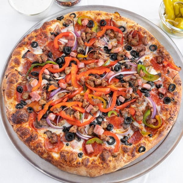 Valentino's Pizza PCH's supreme pizza, loaded with pepperoni, sausage, ham, olives, and bell peppers.